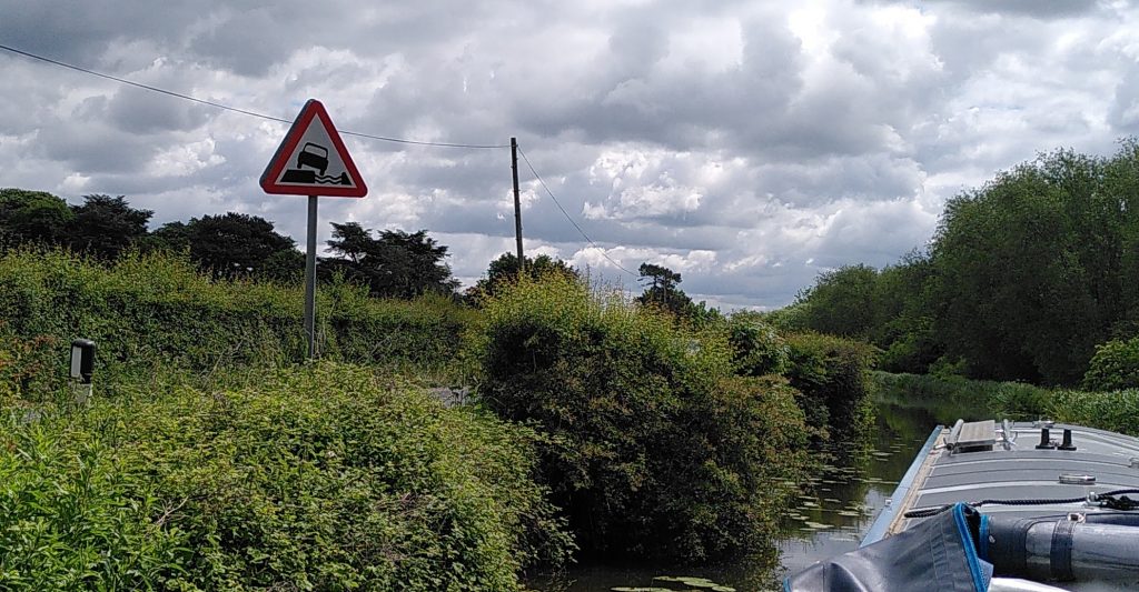 Road Sign Showing Car Falling in to Canal