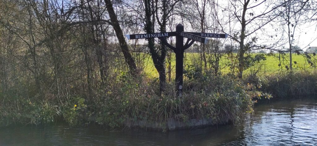 Canal finger signpost pointing to Birmingham, Warwick and Stratford Canal