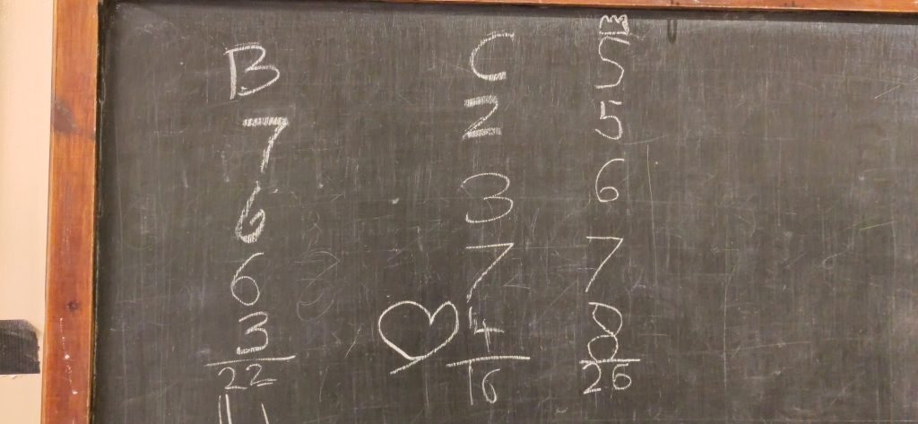 Skittles chalkboard.  A chalkboard for recording skittles scores.  four scores each are recorded for B C and S.  S has the highest total having scored 5 6 7 8.